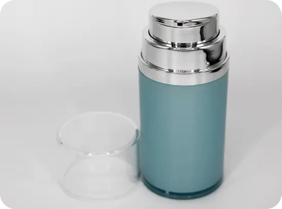A cylindrical metal bottle with a silver pump dispenser and a transparent cap placed next to it. The bottle's body is a light blue color, and it has a sleek, modern design with a reflective silver top.