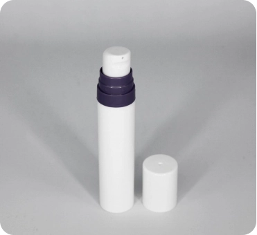 Image of a white cylindrical container with a purple dispenser cap. The container's white lid is removed and placed next to it. The container appears to be for a cosmetic or skincare product, such as a roll-on deodorant or lotion.
