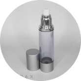 A tall, transparent pump bottle with a silver base and top. The bottle's cap is removed and placed beside it, revealing the white pump dispenser on top. The background is plain and light-colored.