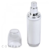 A clear airless pump bottle with a silver pump top. The clear lid is removed and placed beside the bottle.