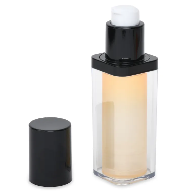 A clear rectangular airless pump bottle with black accents, filled with a light-colored liquid. The bottle has a black pump dispenser on top, and the matching black cap is placed beside it. 