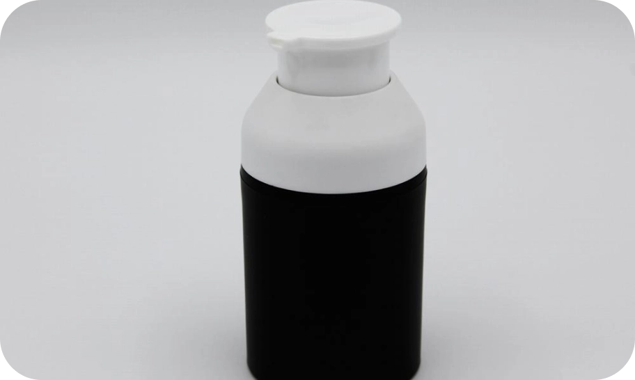 A black cylindrical bottle with a white pump dispenser on a plain white background.
