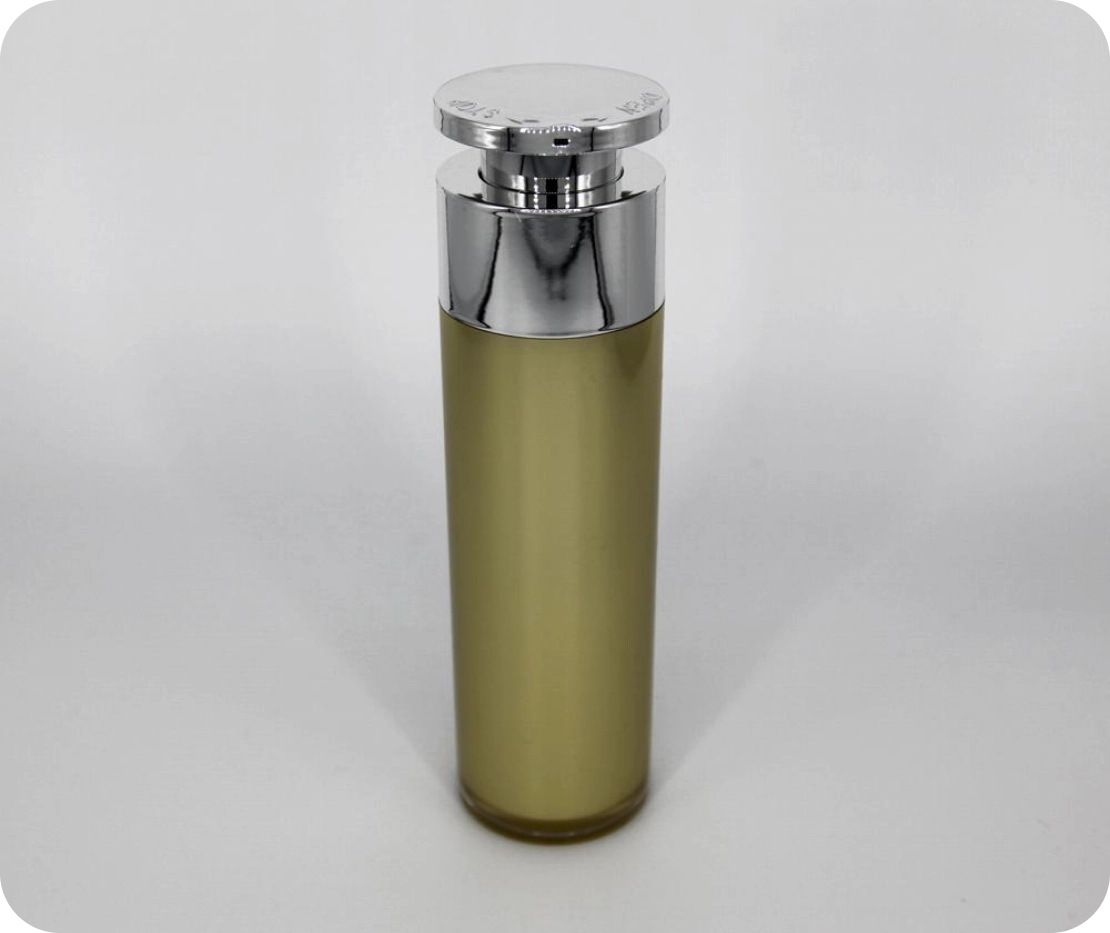 A tall, cylindrical perfume bottle with a shiny silver cap. The body is a translucent, muted olive green, allowing the liquid inside to be slightly visible. The cap has engraved text around the edge. The background is plain white.