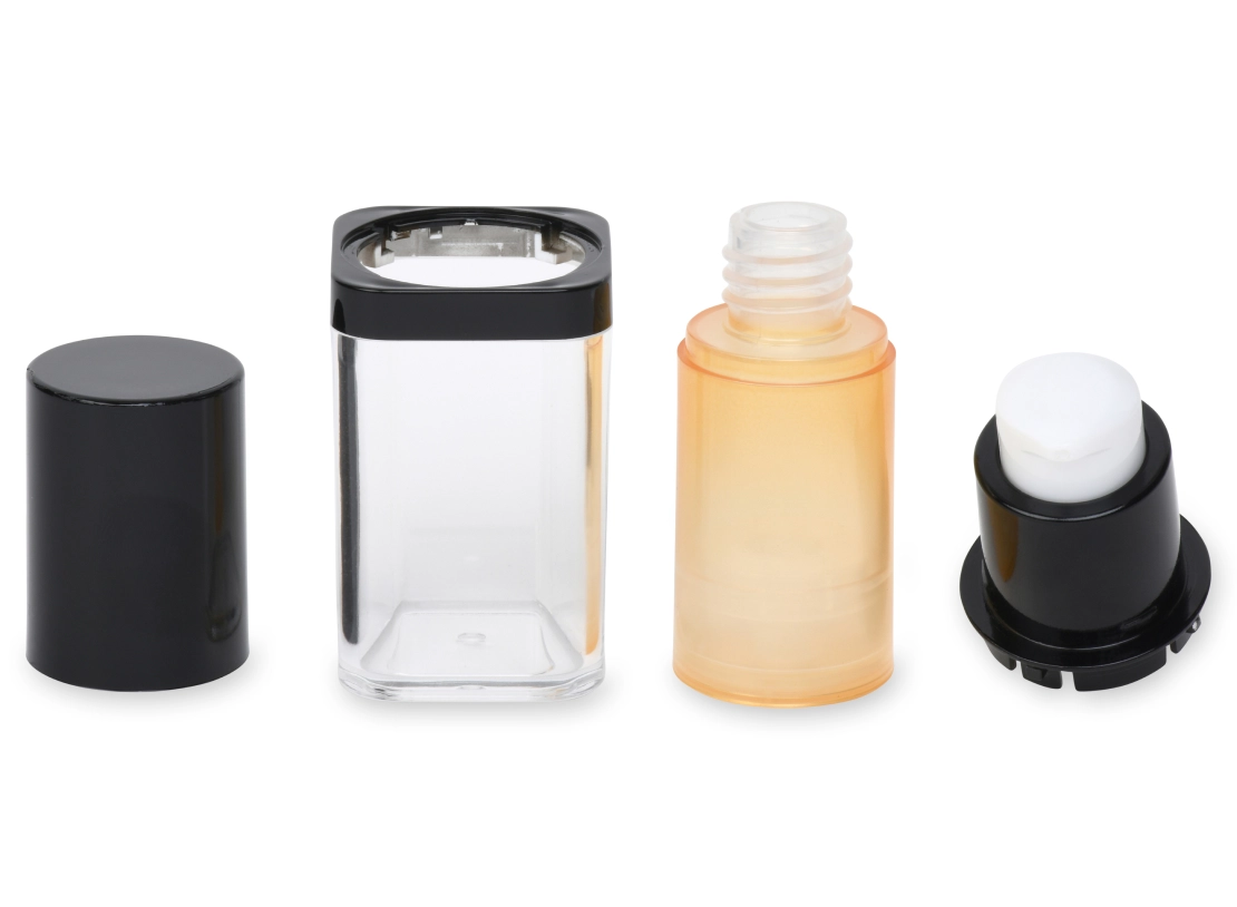 Four disassembled refillable deodorant containers are displayed horizontally. From left to right: a black cap, a clear cylindrical body with a black base, a transparent orange inner container, and a white roll-on ball mechanism with a black base.