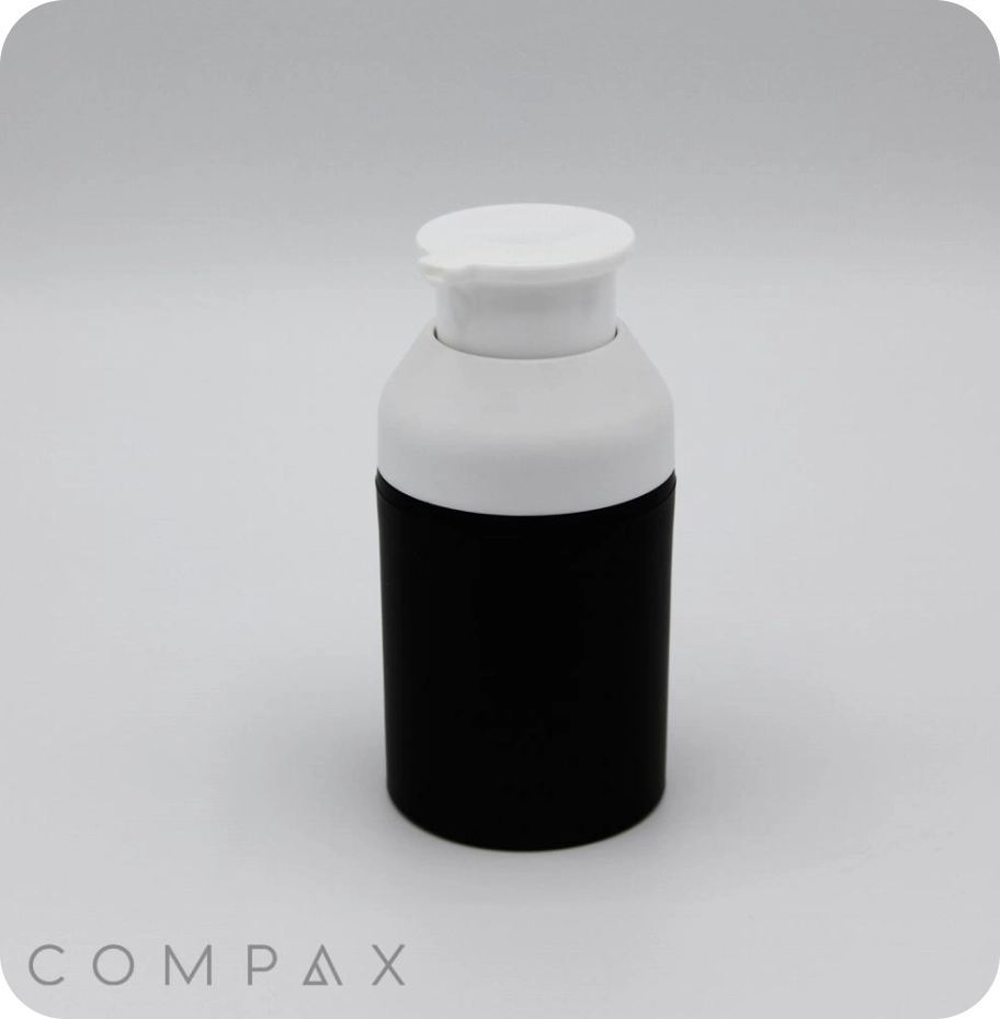 A small black and white bottle with a pump dispenser, labeled with the text COMPAX at the bottom left corner, is displayed against a plain white background.