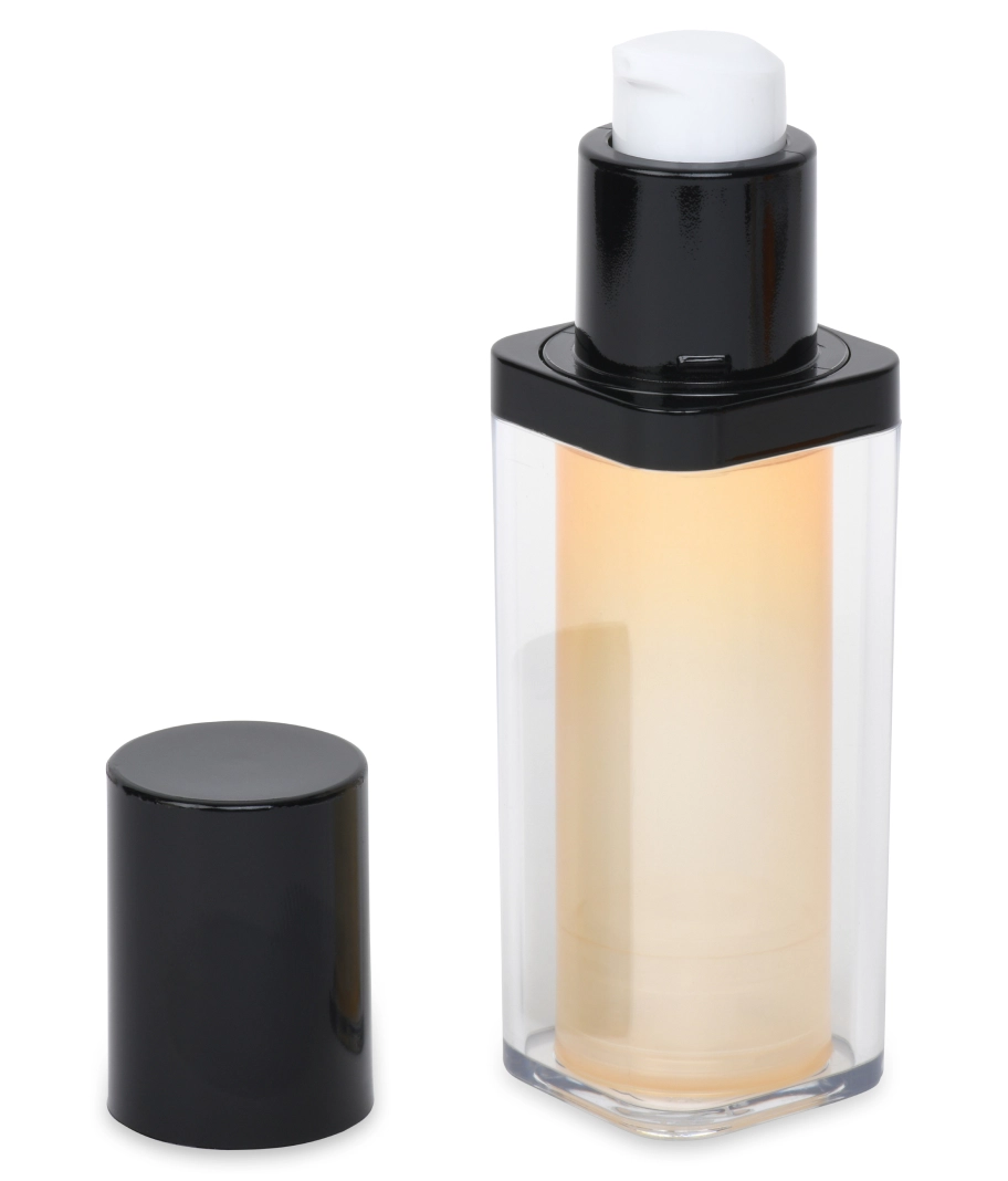A clear rectangular pump bottle with a black cap, partially filled with a light beige liquid, possibly lotion or serum. The cap is placed to the left of the bottle.
